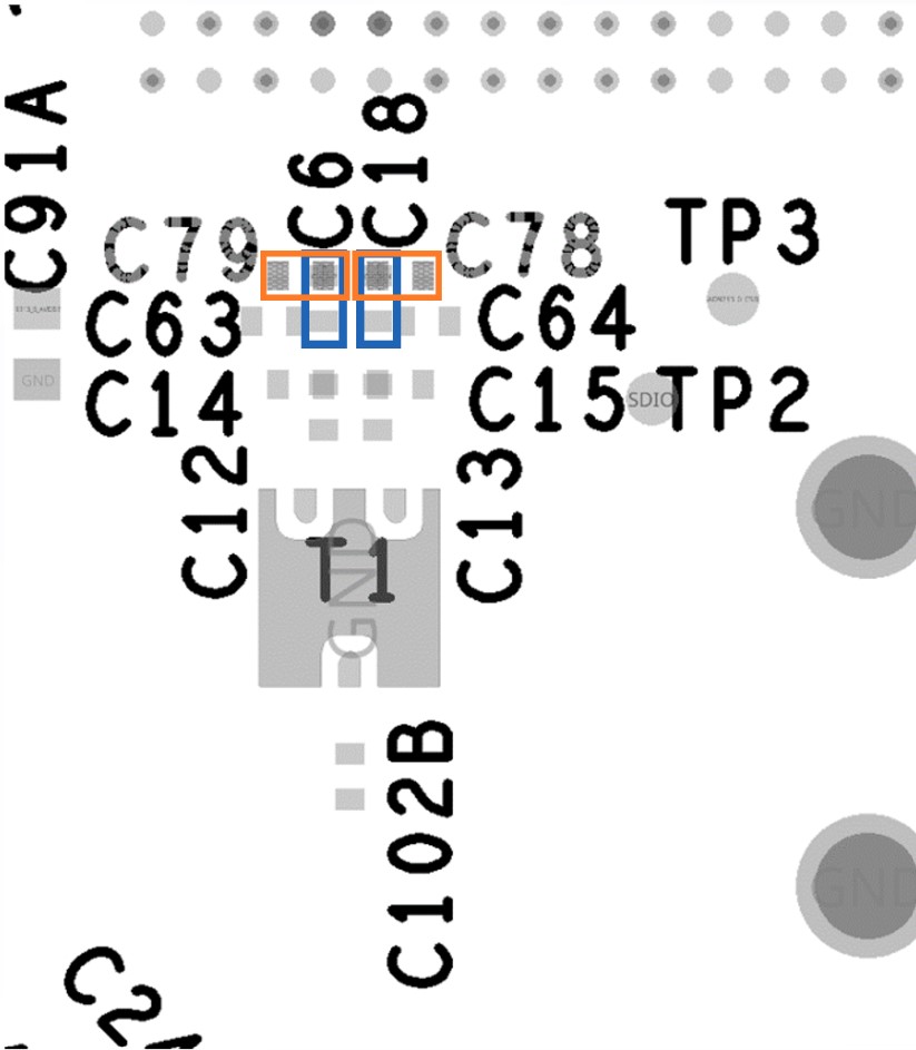 Zoomed view showing on-board (orange) and external (blue) clocking capacitor positions