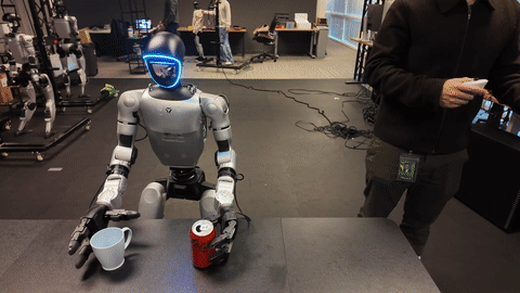 Unitree G1 performing bimanual cup-and-can manipulation beside an operator