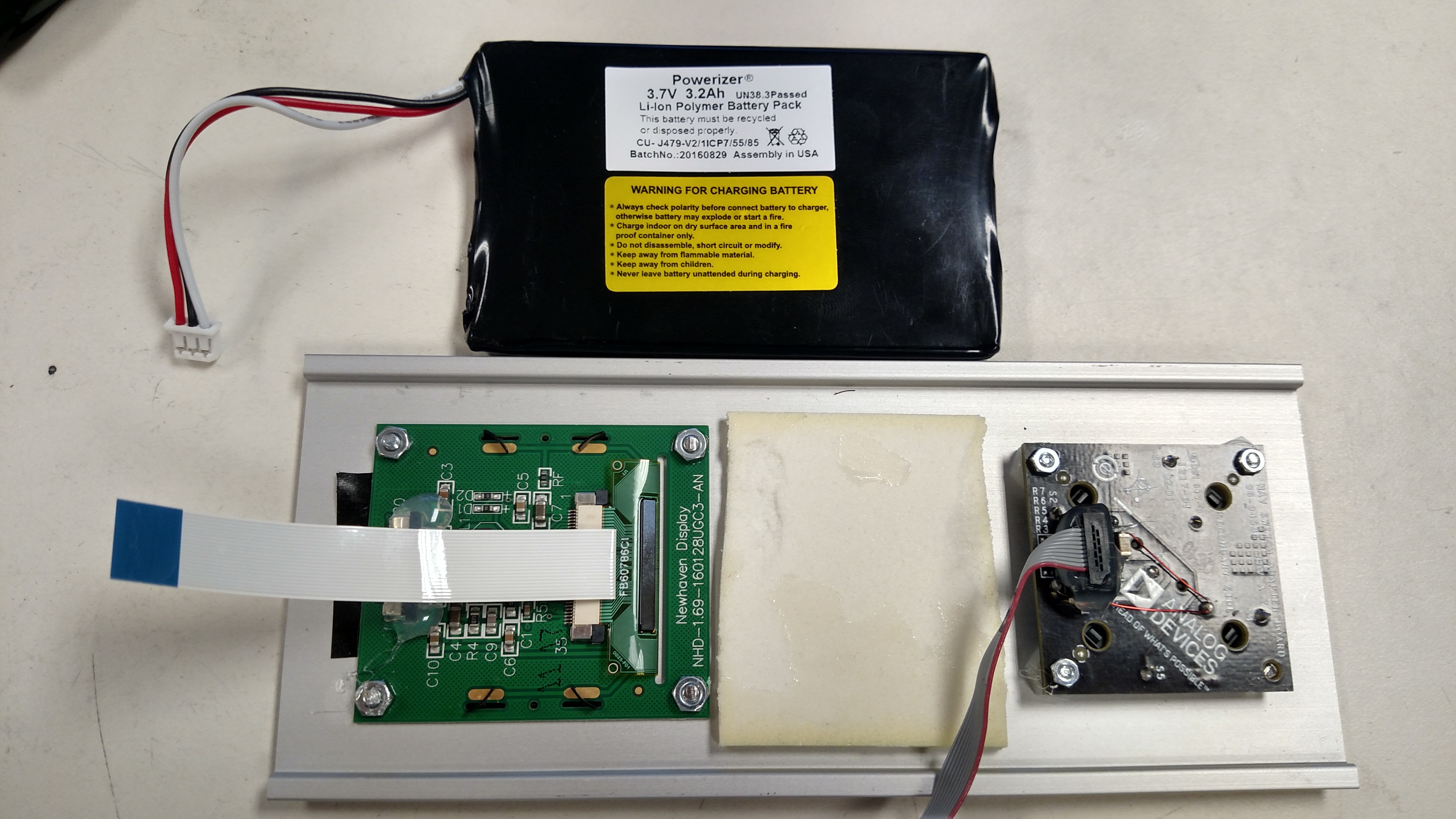 https://media.githubusercontent.com/media/analogdevicesinc/documentation/main/docs/solutions/reference-designs/pzsdr/images/belly_plate_with_battery_on_side.jpg