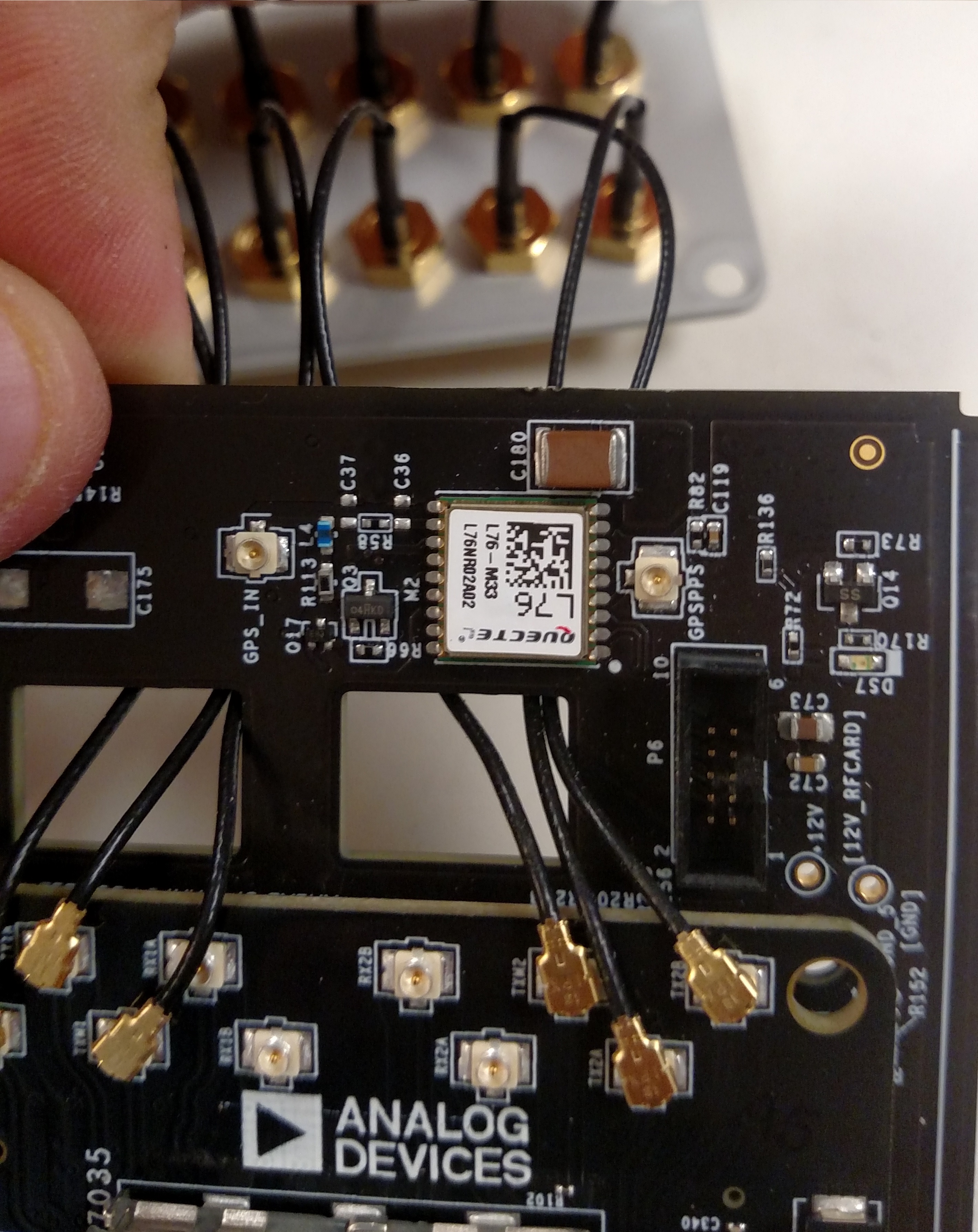 https://media.githubusercontent.com/media/analogdevicesinc/documentation/main/docs/solutions/reference-designs/pzsdr/images/feeding_tx_cables_through_holes_2_.jpg