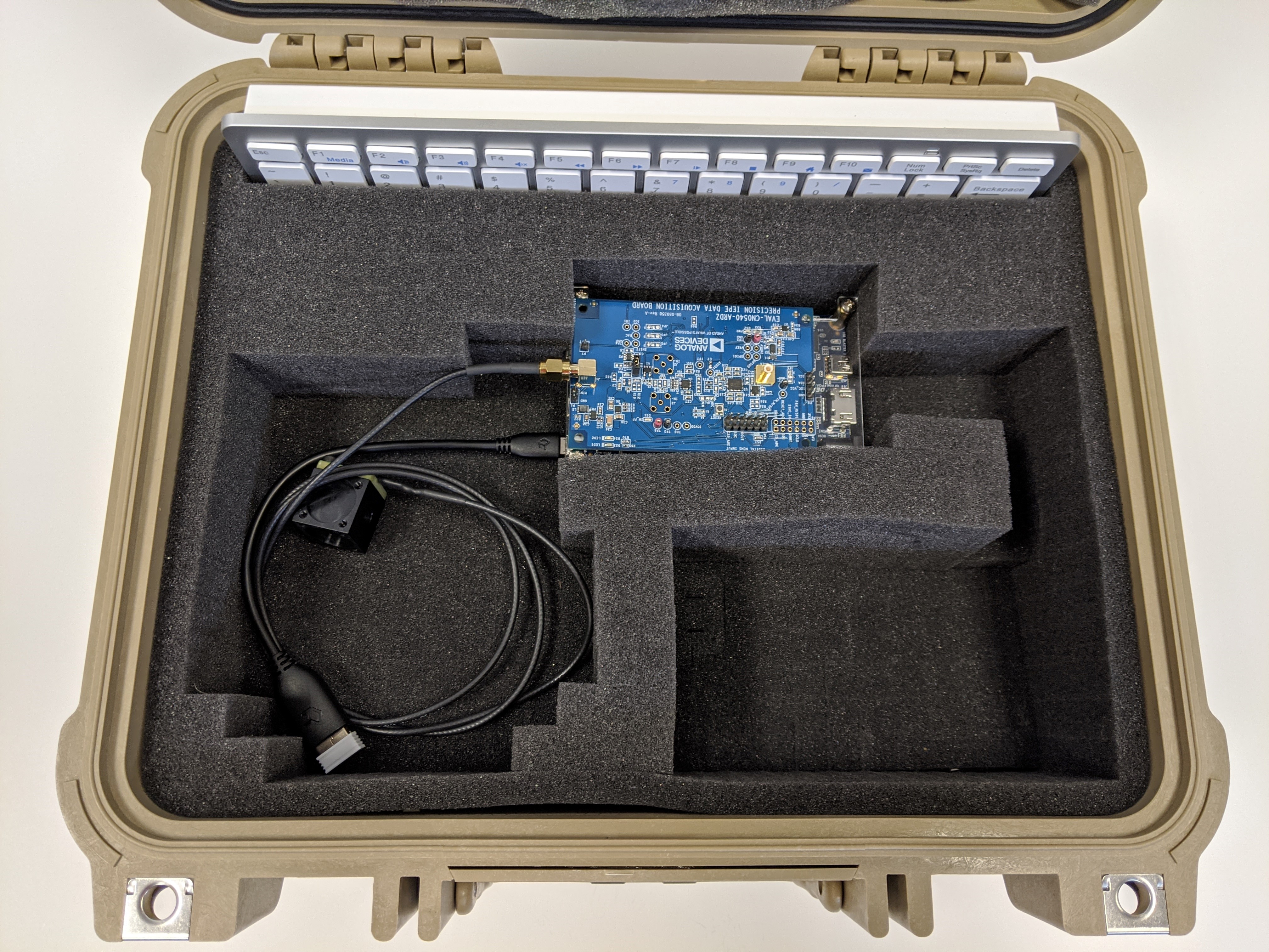 https://media.githubusercontent.com/media/analogdevicesinc/system-level/main/docs/solutions/reference-designs/cn0549/images/cn0549_pelican_case_buildup_cn0540_cn0532_de10_otg2.jpg
