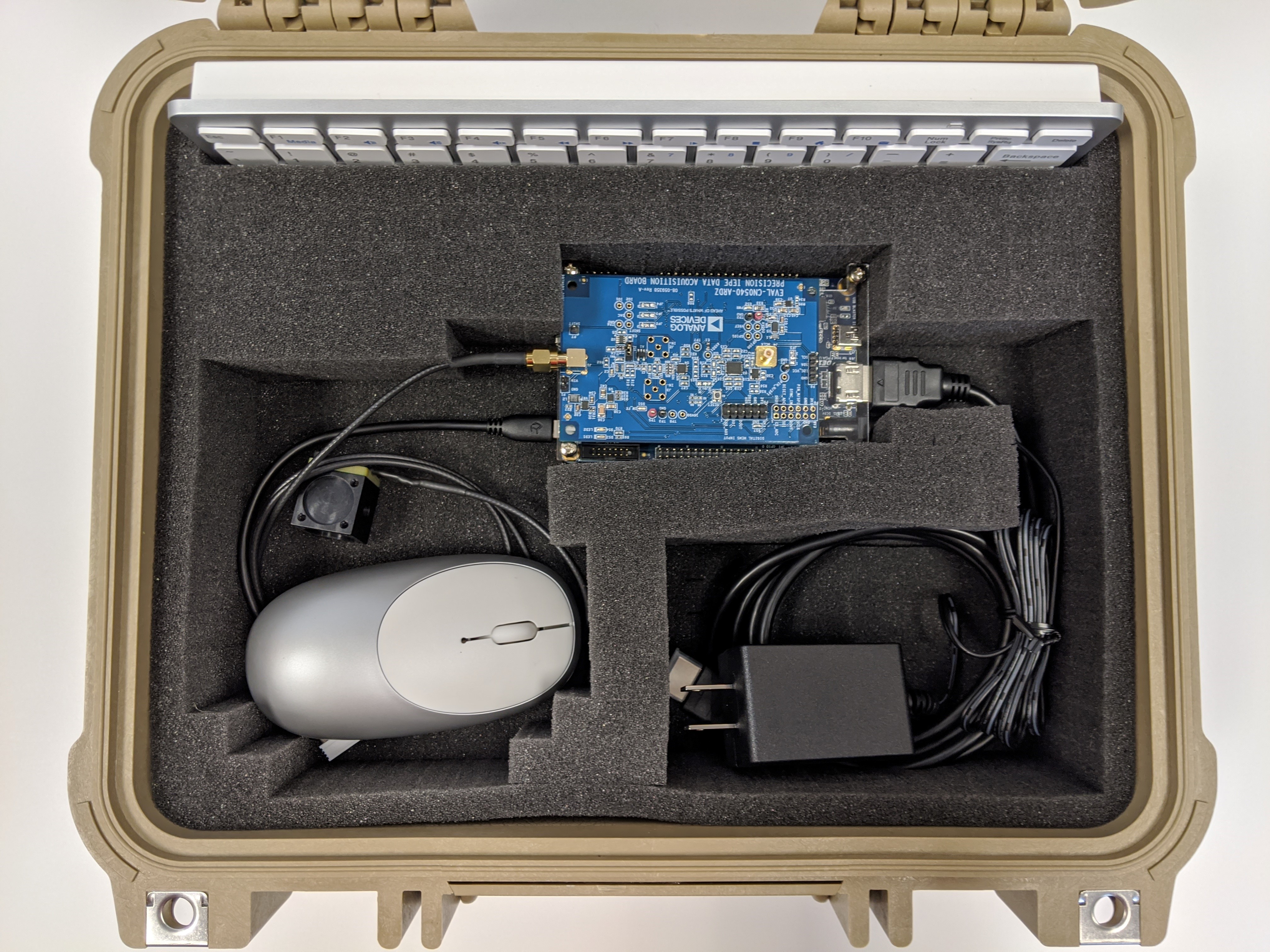 https://media.githubusercontent.com/media/analogdevicesinc/system-level/main/docs/solutions/reference-designs/cn0549/images/cn0549_pelican_case_buildup_cn0540_cn0532_de10_otg_mouse_hdmi_power1.jpg